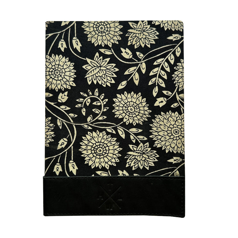 Floral patterned notebook with gold flowers on a black background