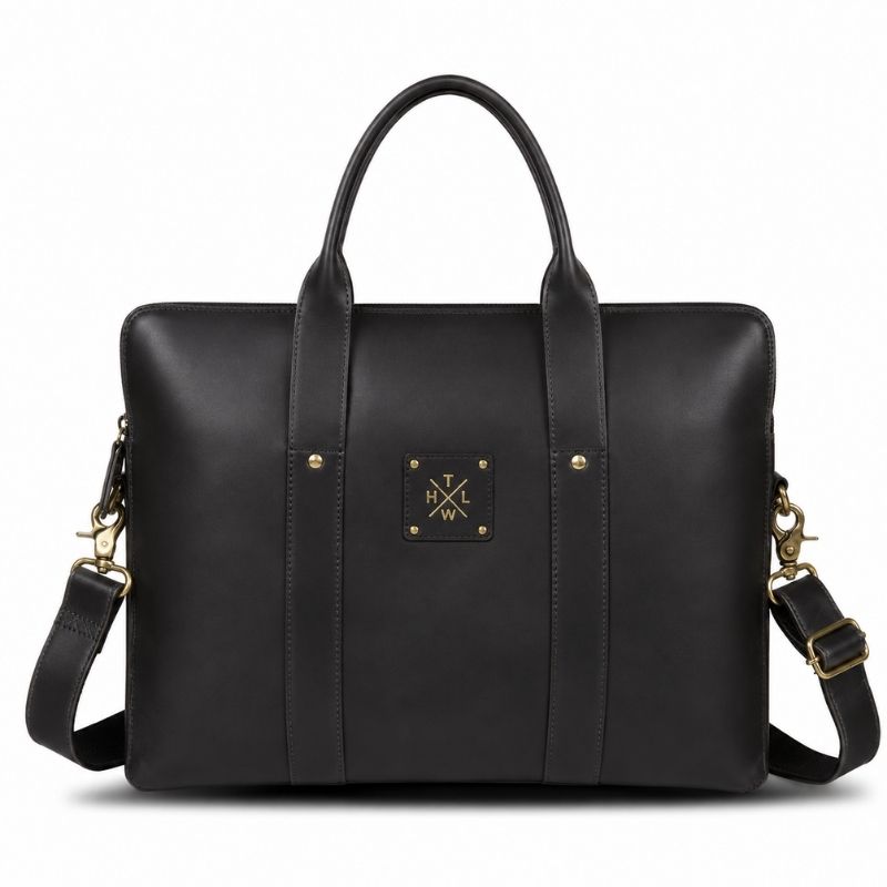 Black leather bag with gold accents on a white background