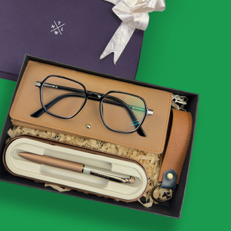 Glasses and pen set in a box with a green background