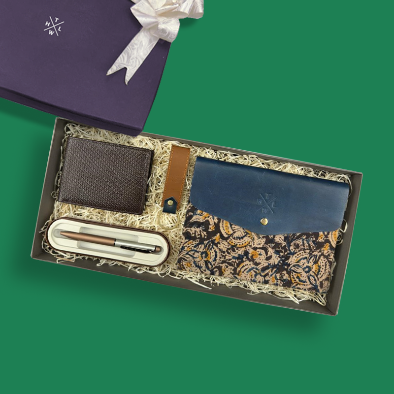 Gift set with wallet, pen, and case on a green background