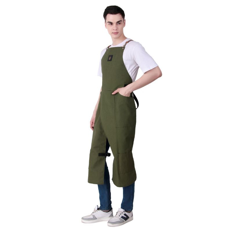 Person wearing a green apron over a white shirt and blue jeans on a white background