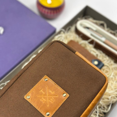 Brown fabric case with leather patch on a white surface