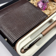 Brown leather wallet and rose gold pen in a box