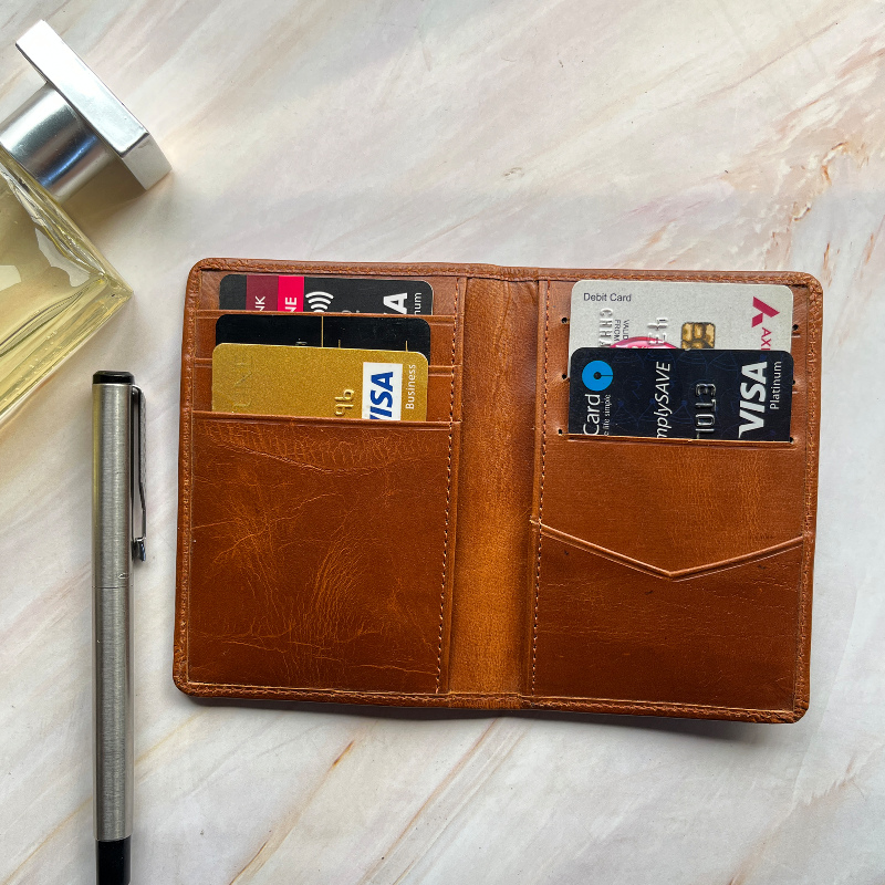 Brown leather wallet with cards on a marble surface