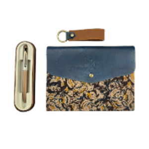 Blue leather clutch with patterned flap, pen case, and keychain on a white background