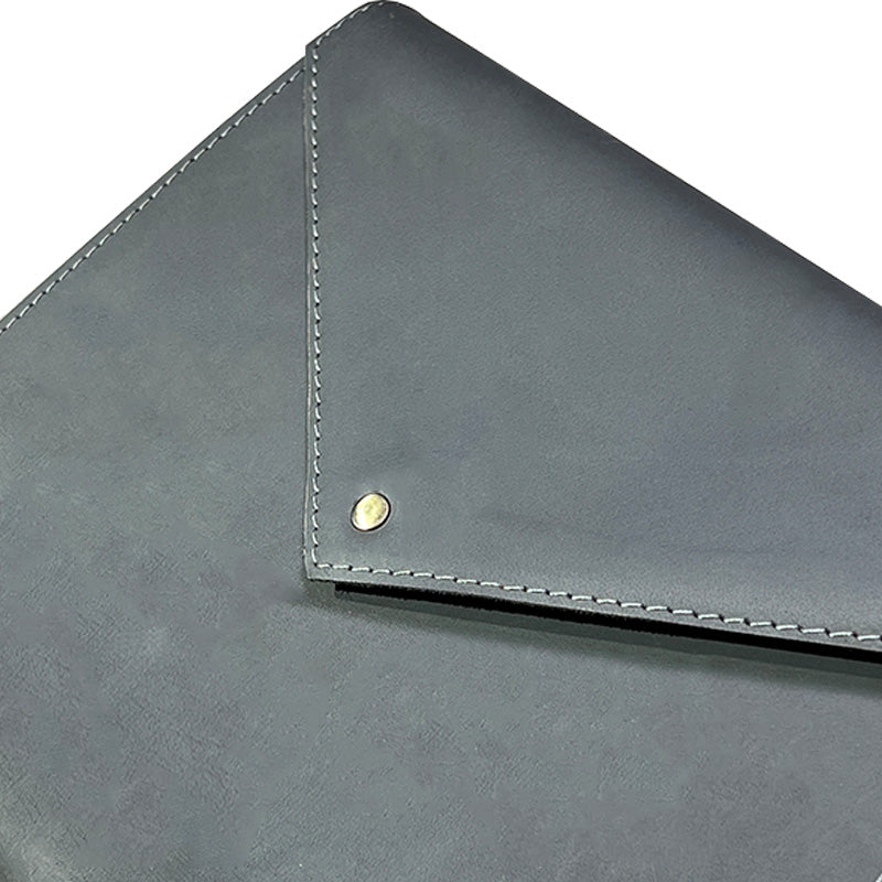 Close-up of a gray leather envelope with stitching detail on a white background