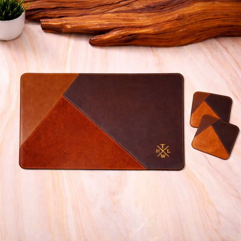 Brown leather placemat with two coaste with geometric design and coasters on a wooden surfac