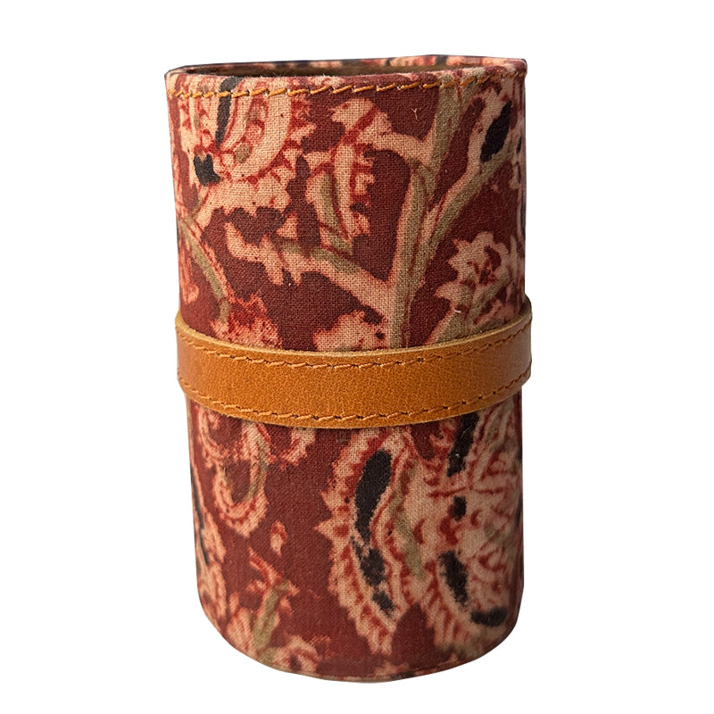 Cylindrical fabric holder with floral pattern and brown band on a white background