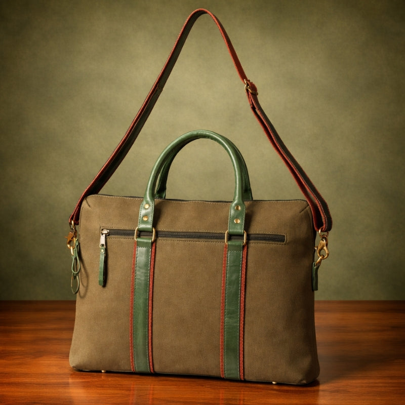 Brown canvas & leather bag with green accents on a wooden surface and green background