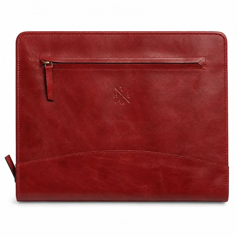 Closed red leather portfolio with front zipper pocket.