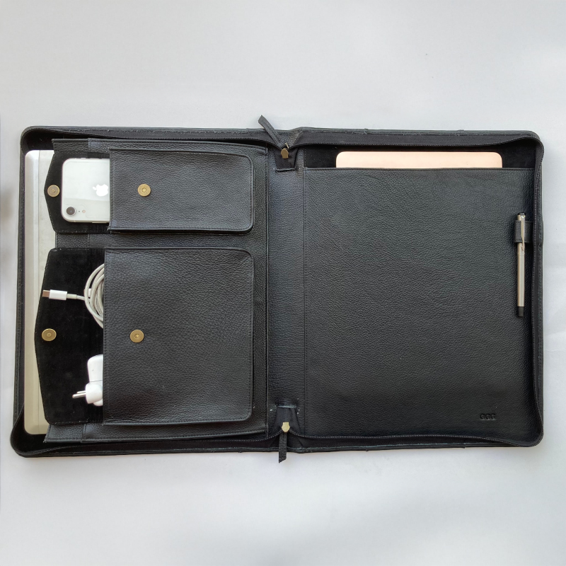 Black leather organizer with compartments on a white background