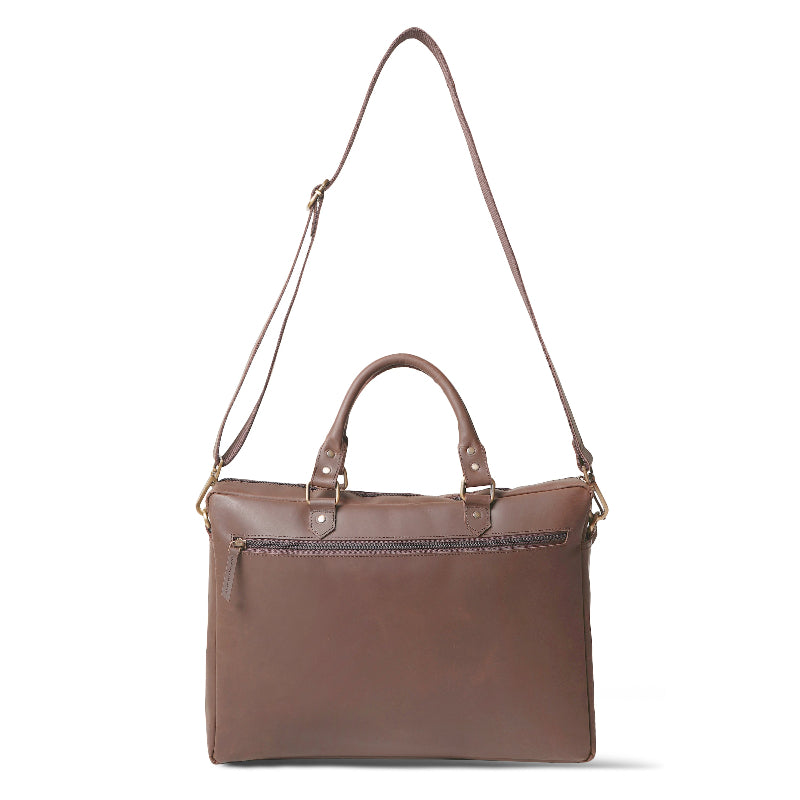 Brown leather bag with a shoulder strap on a white background