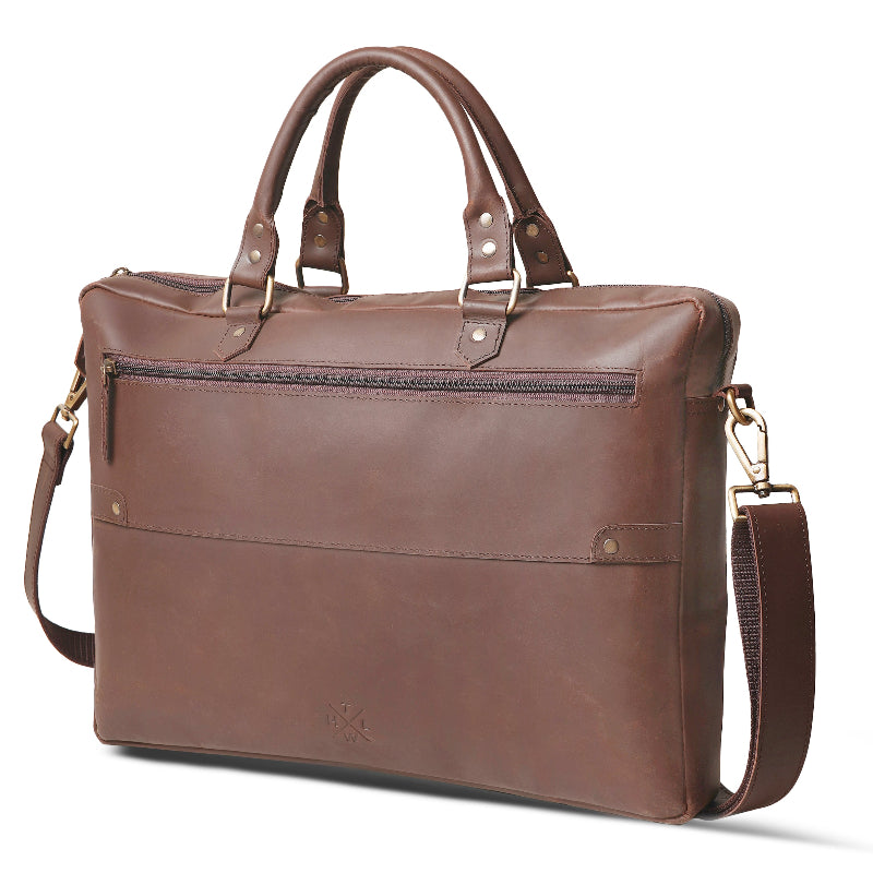 Brown leather briefcase with shoulder strap on a white background