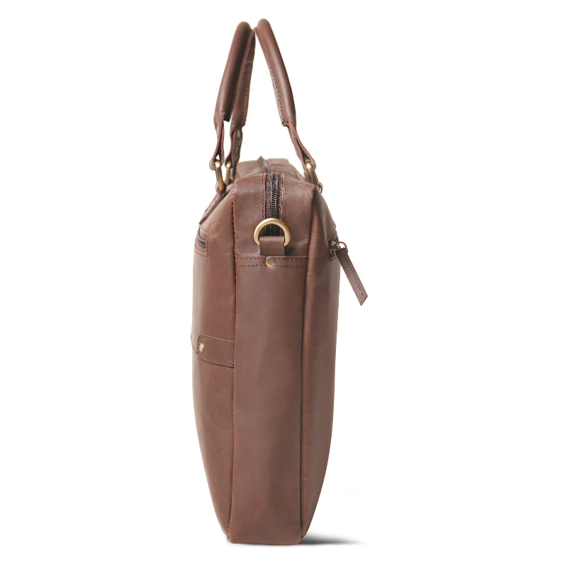 Brown leather handbag with gold accents on a white background