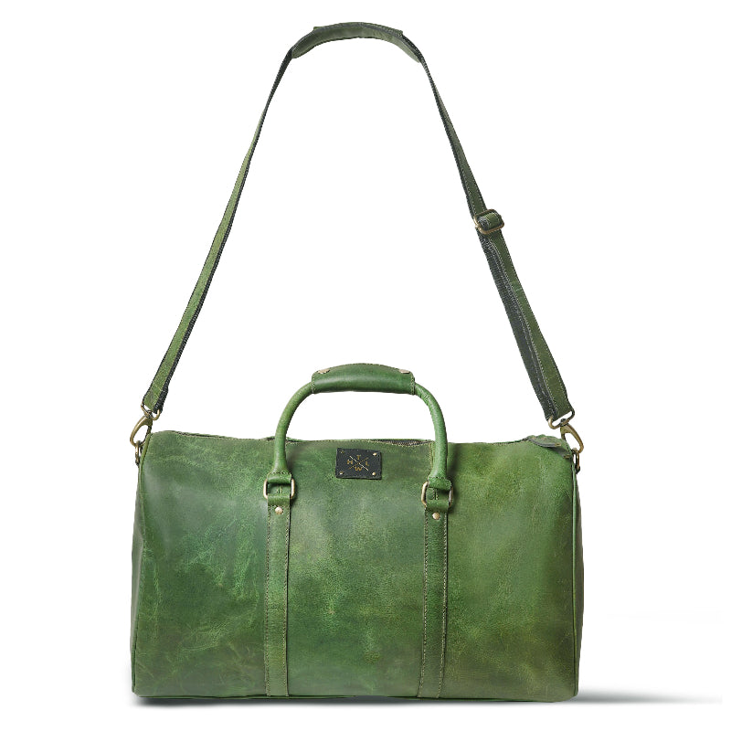 Green leather duffel bag with a strap on a white background