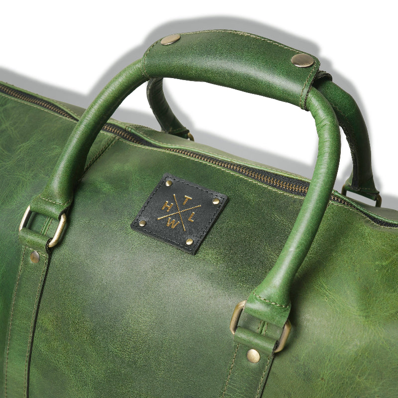 Green leather bag with a brand logo on a white background