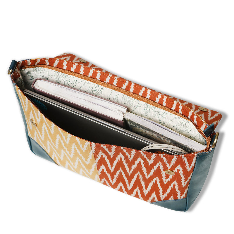 Patterned clutch bag with a white interior on a white background