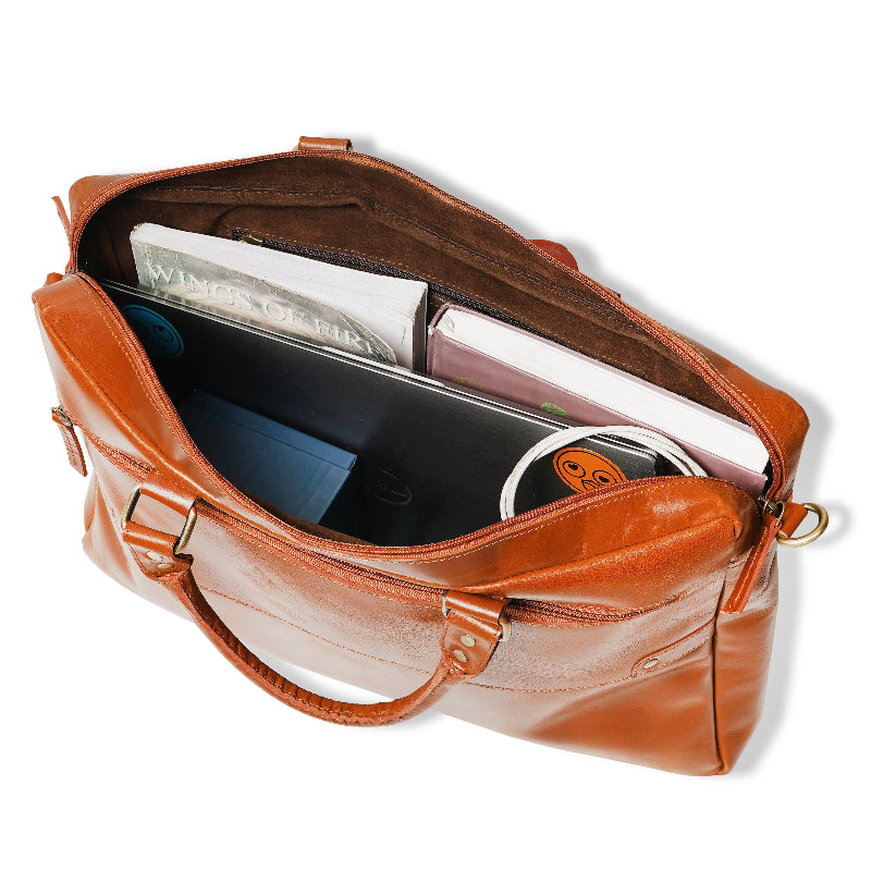Brown leather bag with items inside on a white background