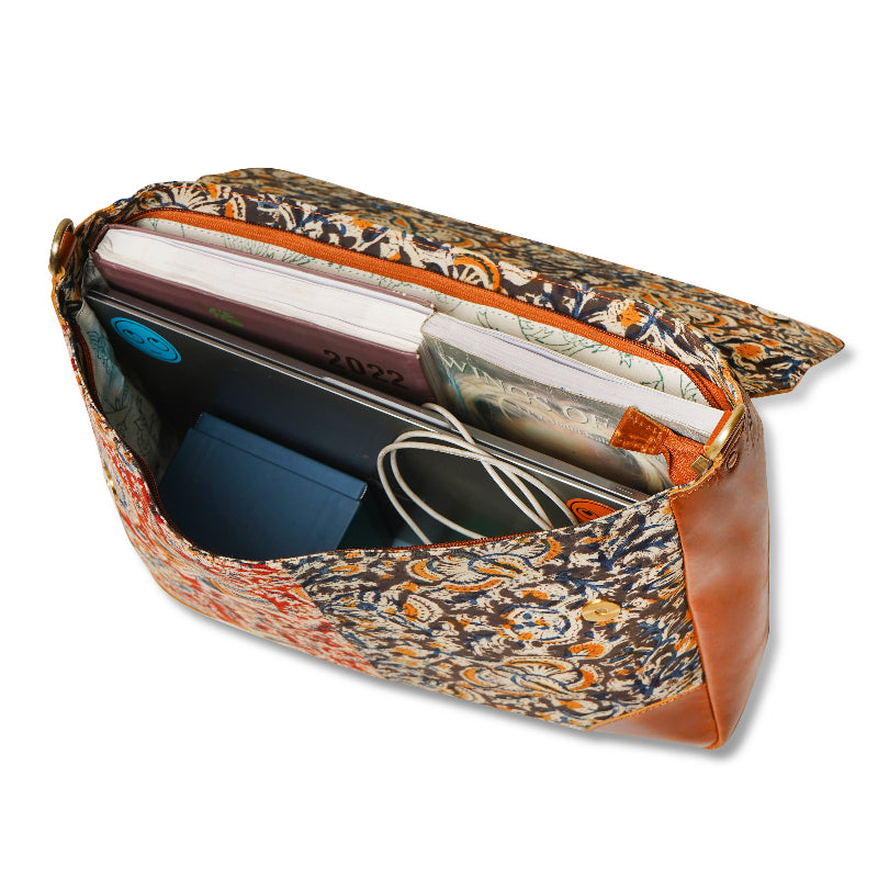 Patterned pouch with a phone, cable, and other items on a white background