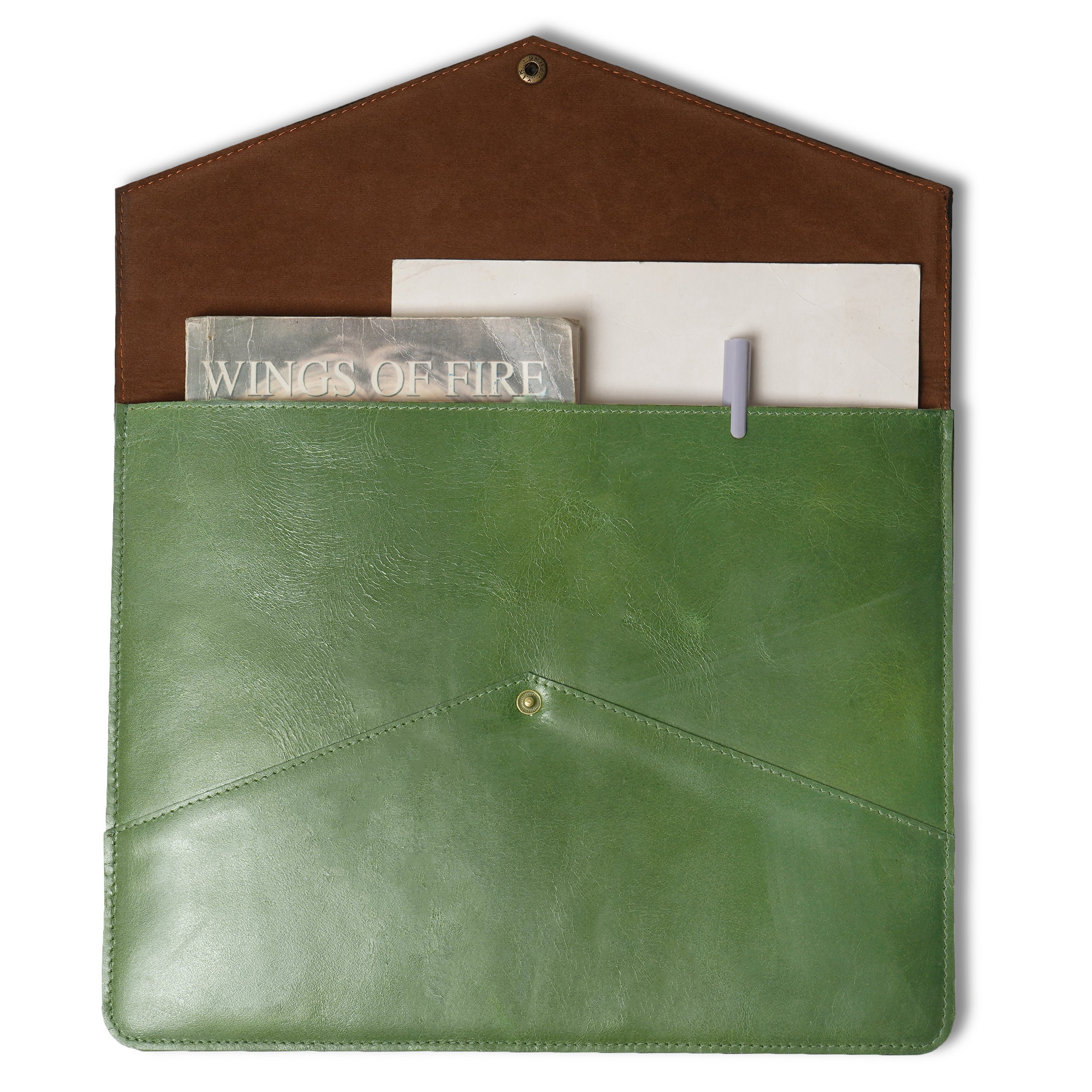 Green leather pouch with a brown flap containing a book and pen on a white background