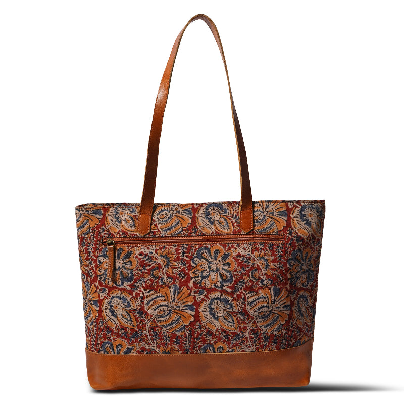 Tote bag with floral pattern and brown leather accents on a white background