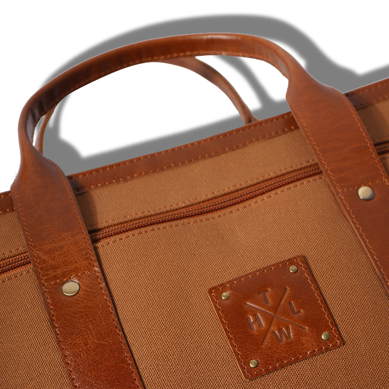 Brown leather bag with a visible brand logo on a white background