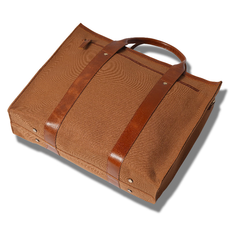 Brown leather bag with straps on a white background