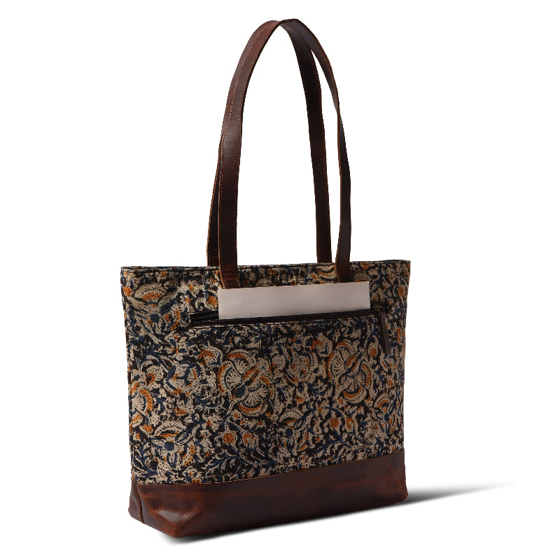 Tote bag with floral pattern and brown leather accents on a white background
