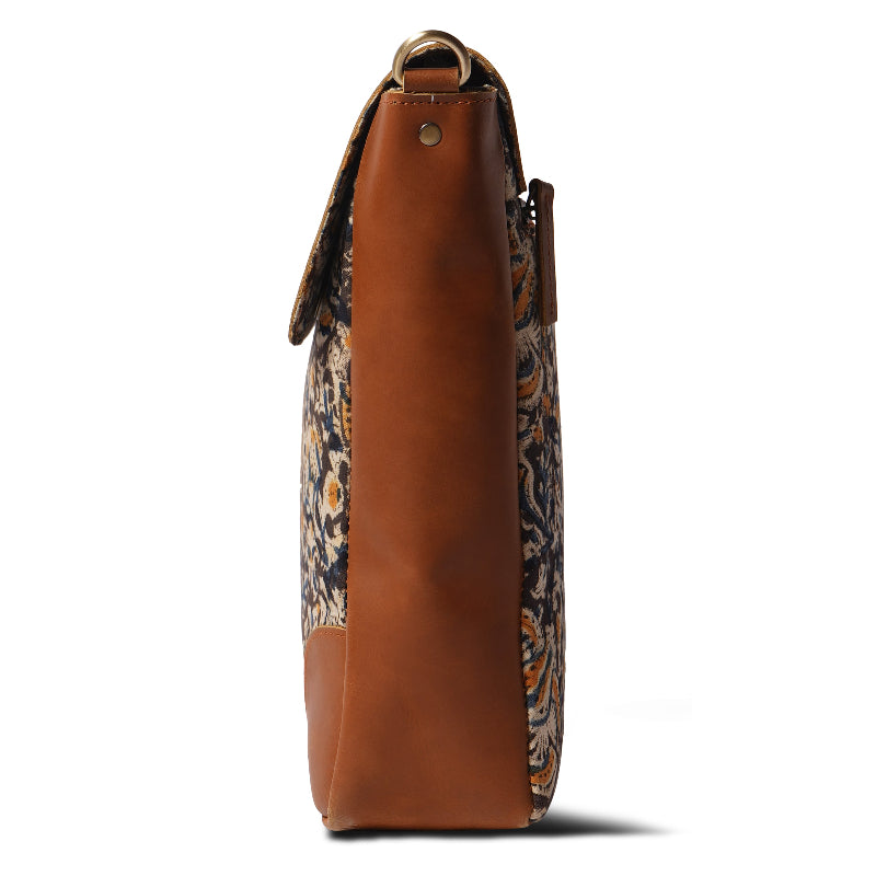 Brown leather bag with patterned interior on a white background