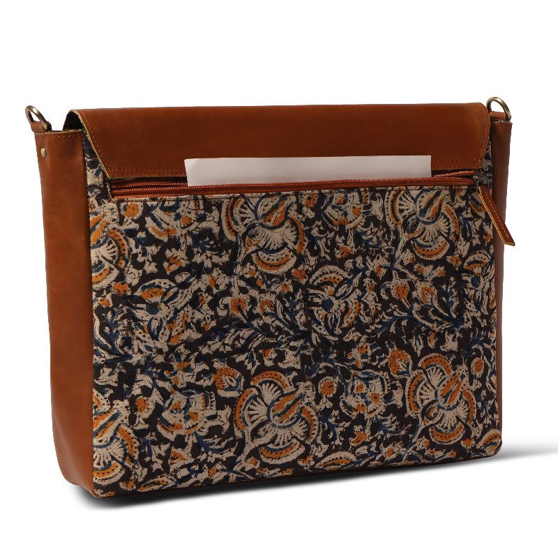 Patterned bag with brown leather accents on a white background