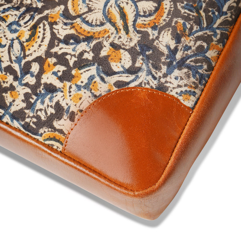 Close-up of a patterned mat with brown leather corner on a white background