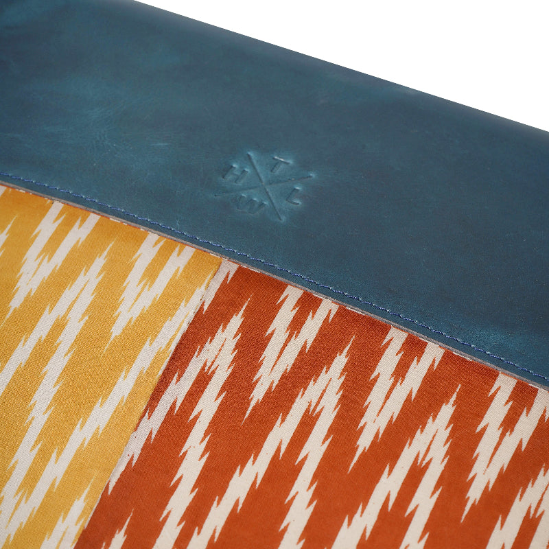 Close-up of a product with a blue top section and colorful patterned bottom section.