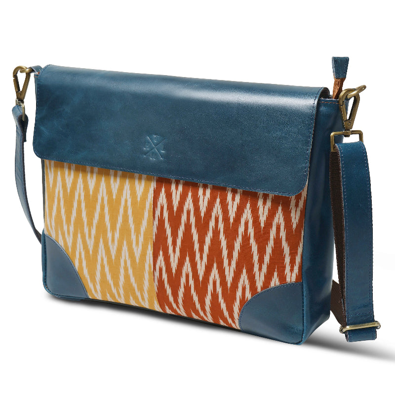 Blue and patterned shoulder bag on a white background