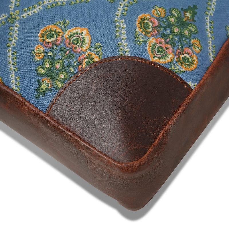 Close-up of a brown leather product with floral fabric background