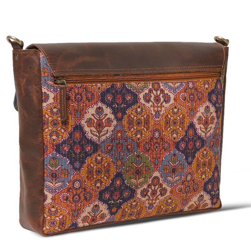Patterned bag with brown leather sides on a white background