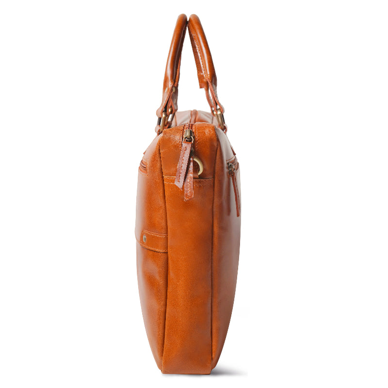 Brown leather handbag with gold accents on a white background