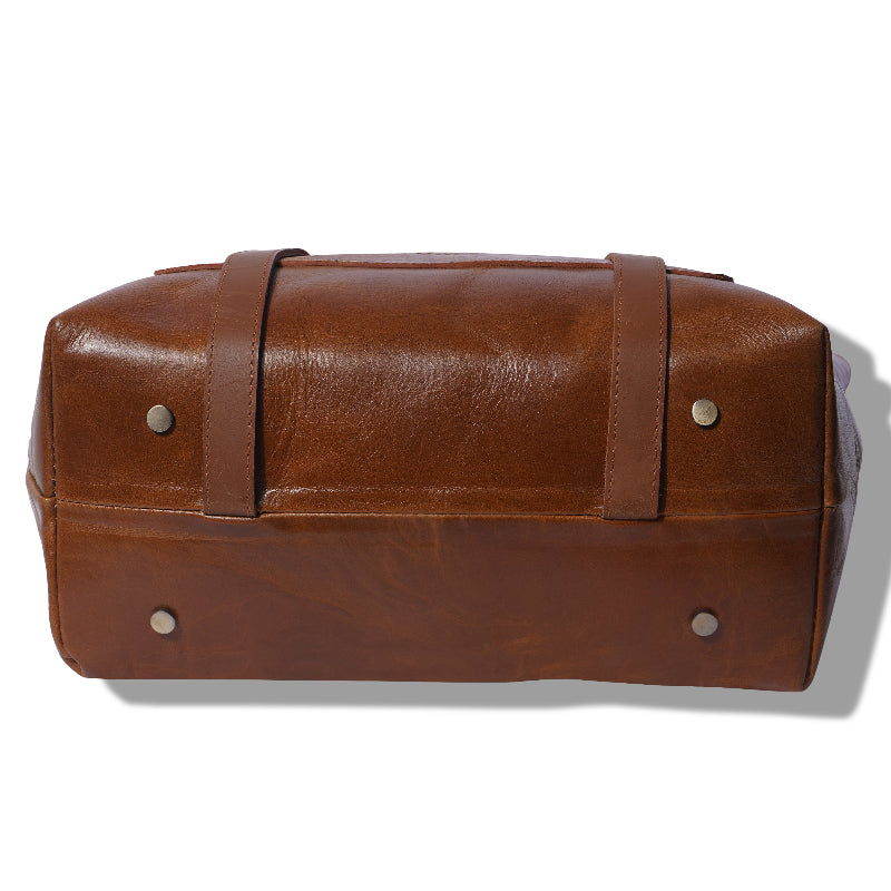 Brown leather bag with strap on a white background