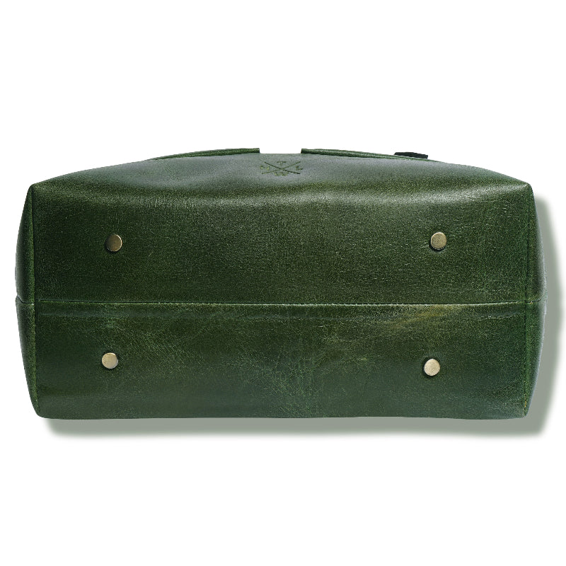 Green leather bag with gold studs on a white background