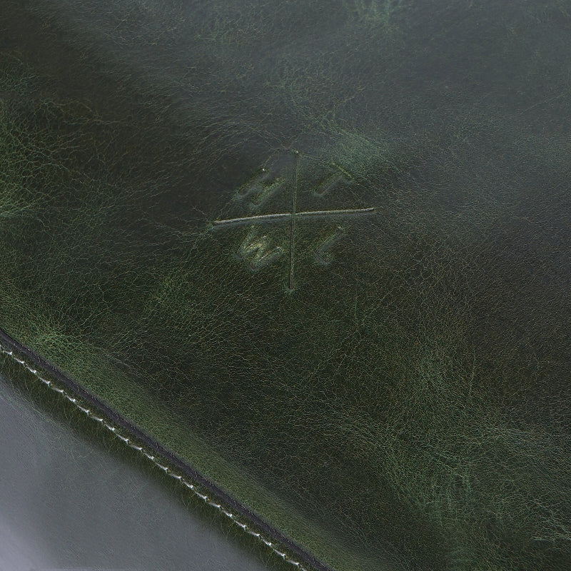 Close-up of a textured green surface with a brand logo.