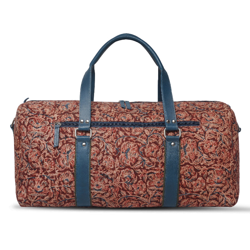 Patterned duffel bag with blue straps on a white background