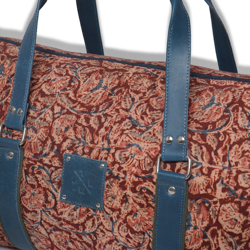 Patterned bag with blue straps on a white background