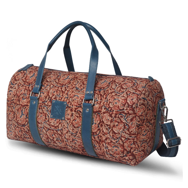 Patterned duffel bag with blue straps on a white background