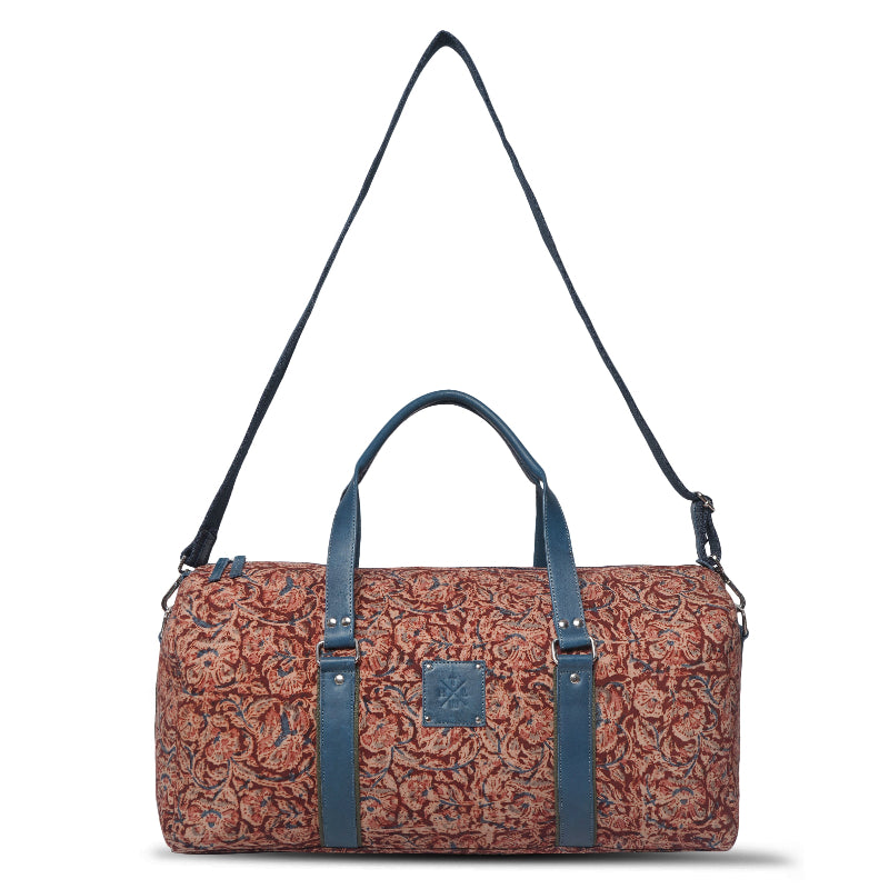 Patterned duffel bag with blue straps on a white background