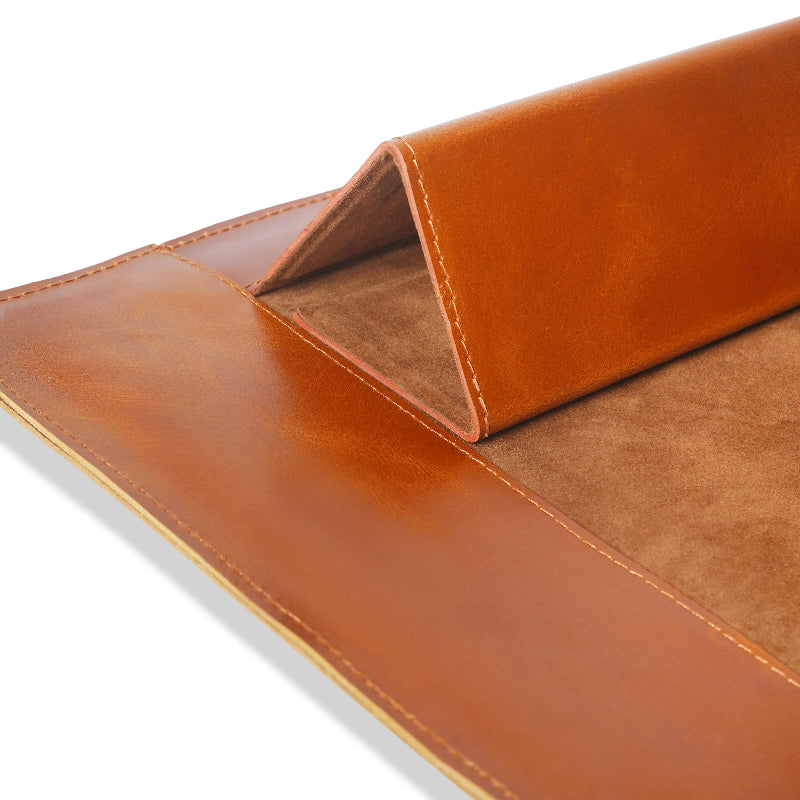 Close-up of a brown leather sleeve with a white background