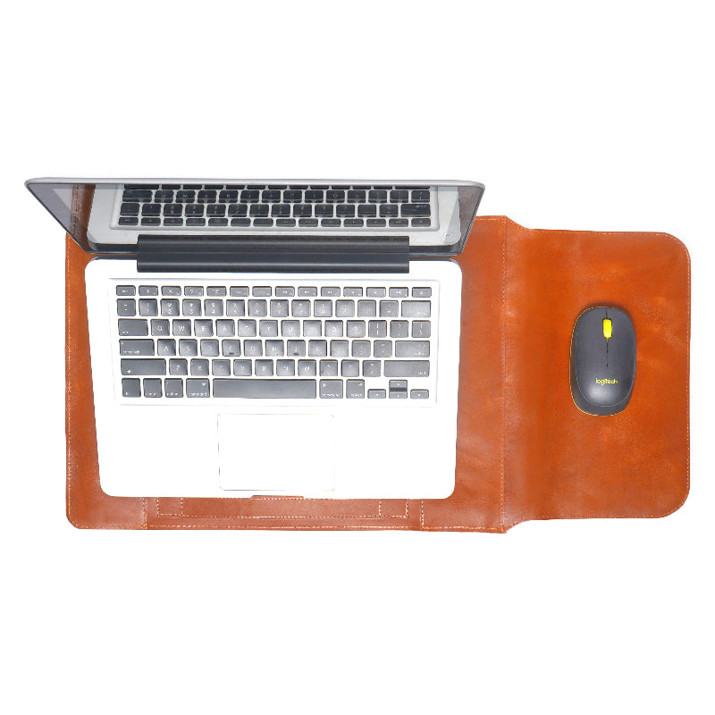 Laptop on a brown sleeve pad with keyboard and mouse