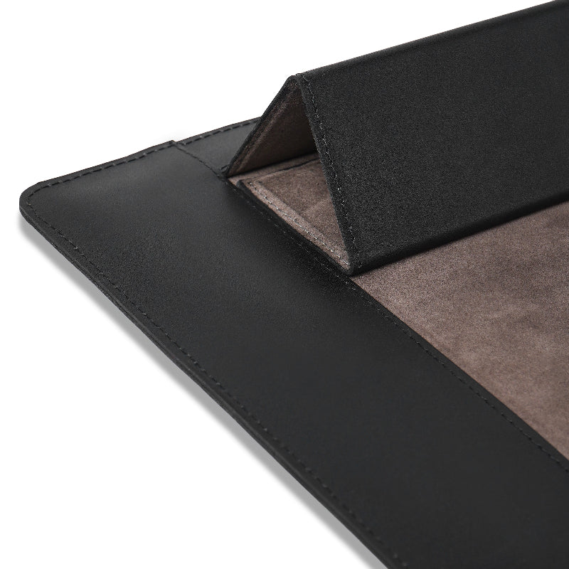 Close-up of a black leather sleeve with a textured brown interior on a white background