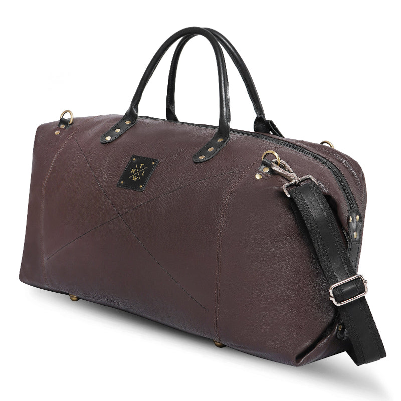 Brown leather duffel bag with black straps on a white background