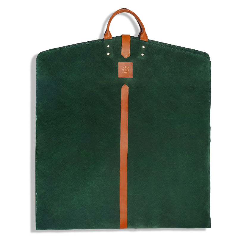 Green garment bag with brown strap and handle on a white background