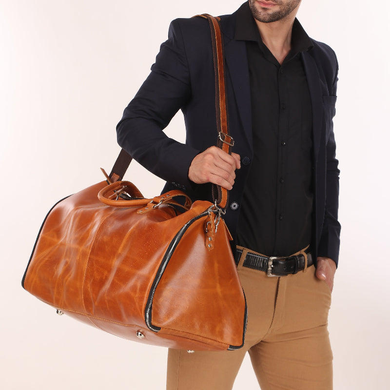 Man holding a large brown leather bag against a white background