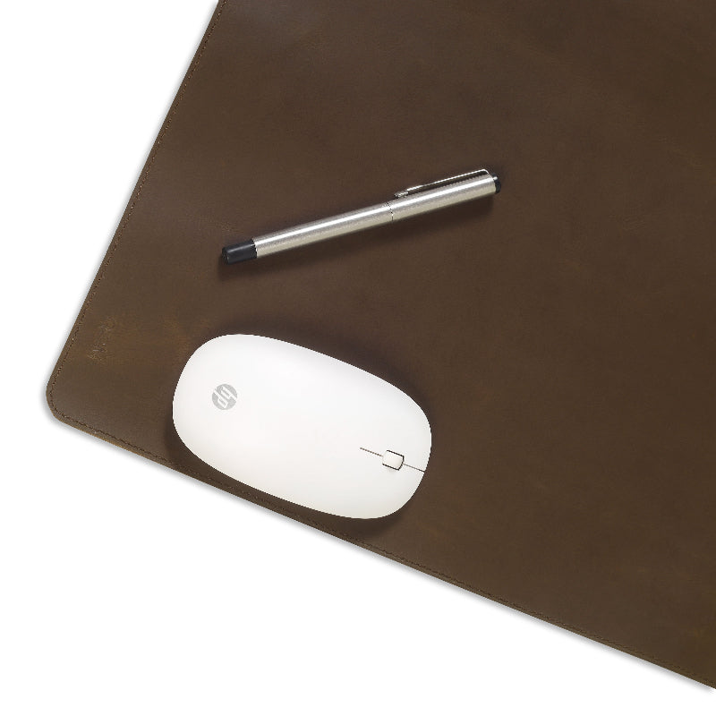 Brown leather desk pad with a white mouse and pen on a white background